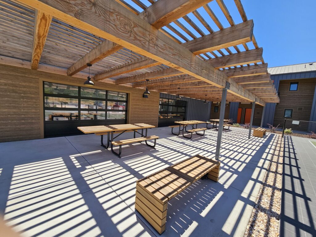 patio with wooden lattice roof and park benches